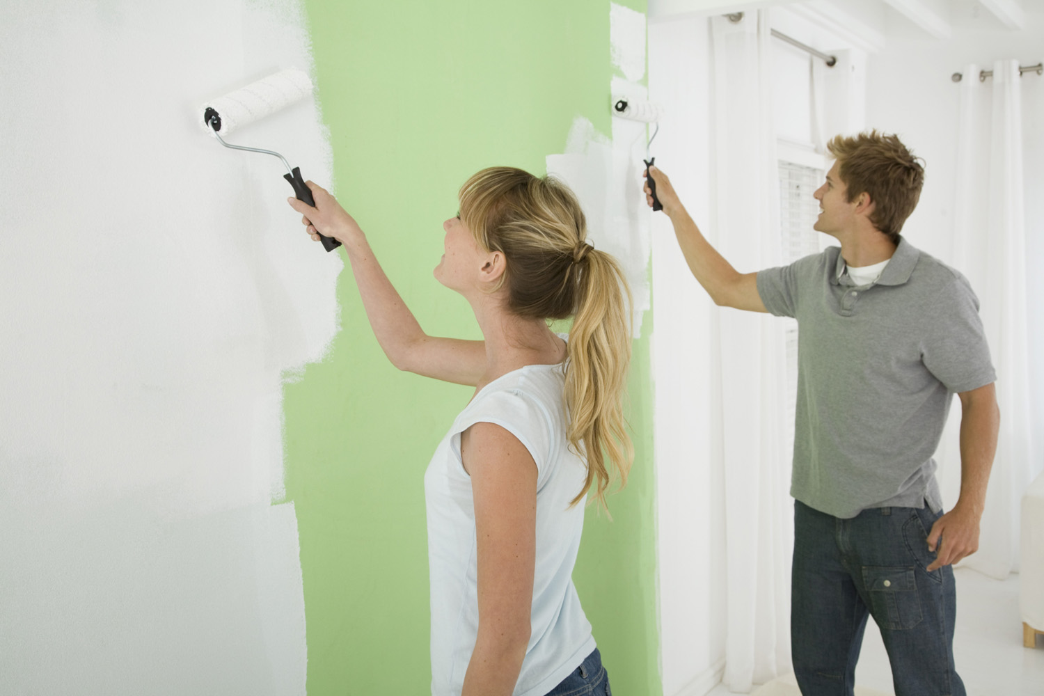 Couple painting wall